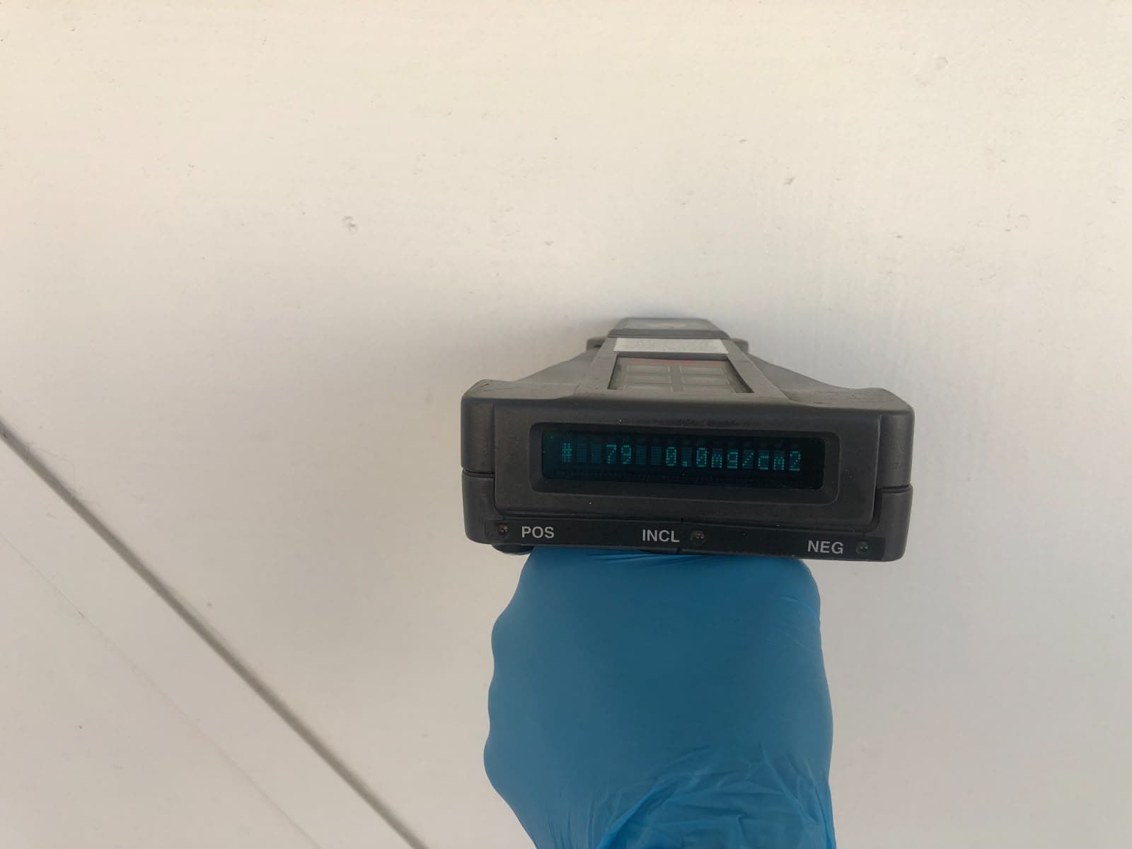 XRF analyzer testing a painted wall for lead