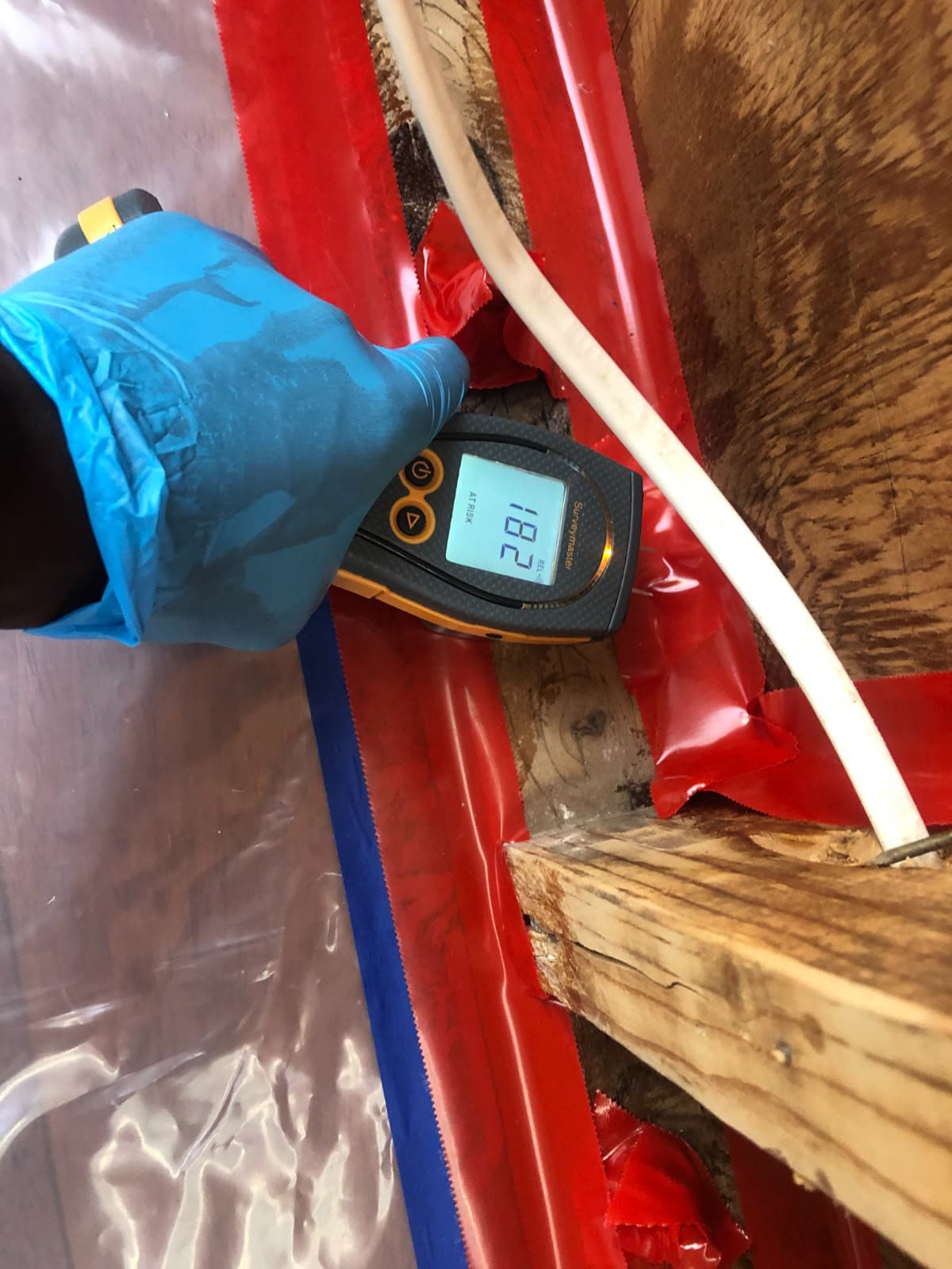 Moisture meter reading taken during a mold assessment inside a containment area
